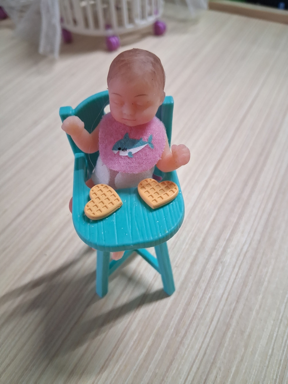 Mini Baby Doll in Teal High Chair with Pink Bib